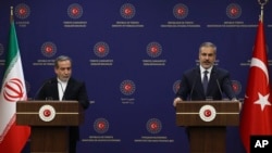 Turkish Foreign Minister Hakan Fidan, right, talks to journalists during a joint news conference with Iran's Foreign Minister Abbas Araghchi following their meeting in Ankara, Dec. 2, 2024.