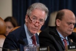 FILE - House Ways and Means Committee Chairman Richard Neal, D-Mass., who is demanding President Donald Trump's tax returns for six years, is joined at right by Rep. Tom Reed, R-N.Y., at a hearing on taxpayer noncompliance in Washington.