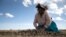 Maxima Ccalla moves dehydrated potatoes on a field in the Carata peasant community, in Punoune, Peru, June 18, 2021.