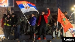 Students and opposition supporters hold flags during a protest over the fatal November 2024 Novi Sad railway station roof collapse, in Nis, Serbia, March 1, 2025.