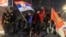 Students and opposition supporters hold flags during a protest over the fatal November 2024 Novi Sad railway station roof collapse, in Nis, Serbia, March 1, 2025.