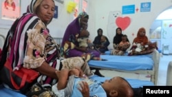 FILE - Children suffering from malnutrition, are treated at Port Sudan Paediatric Center, during a visit by WHO Director-General Tedros Adhanom Ghebreyesus to the country, in Sudan, Sept. 7, 2024. 