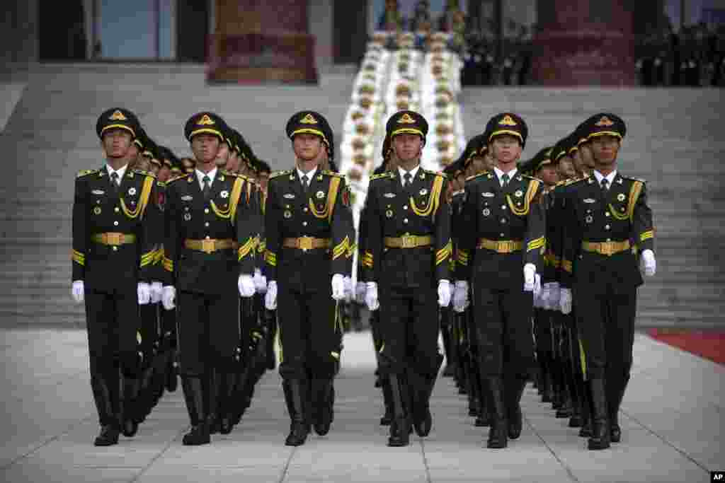 Honor guard members march before a welcome ceremony for Turkish President Recep Tayyip Erdogan at the Great Hall of the People in Beijing, China.