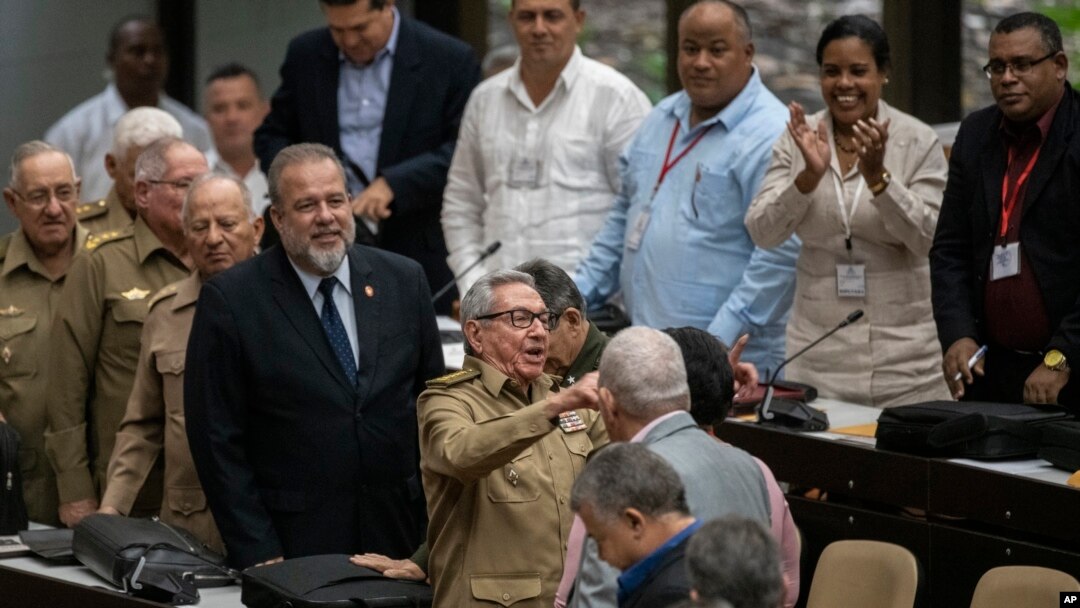 Former Cuban President Raul Castro, center, talks with a member of the assembly while Cuban Prime Minister Manuel Marrero Cruz, center left, looks on at the National Assembly of Popular Power in Havana, Cuba, Dec. 21, 2019.