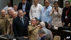 Former Cuban President Raul Castro, center, talks with a member of the assembly while Cuban Prime Minister Manuel Marrero Cruz, center left, looks on at the National Assembly of Popular Power in Havana, Cuba, Dec. 21, 2019.