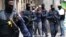 Catalan police officers detain a woman during an anti-drug trafficking operation in Barcelona downtown, Spain, Monday, Oct. 29, 2018.