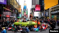 Climate activists participate in an Extinction Rebellion protest in New York, Oct. 10, 2019.