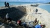 FILE - Workers build a landfill on Tarawa atoll, Kiribati, on March 30, 2004. New Zealand officials said on Jan. 27, 2025, that they are reconsidering all development funding to Kiribati.