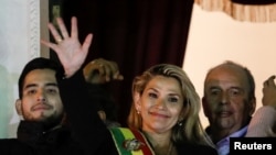 Bolivian Senator Jeanine Anez gestures after she declared herself as interim President of Bolivia, at the balcony of the Presidential Palace, in La Paz, Bolivia, Nov. 12, 2019. 