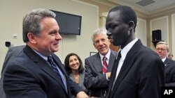 US Rep. Christopher Smith (l) greets Ker Deng, a young man who in recent years was freed from slavery in Sudan during which he was blinded, October 4, 2011