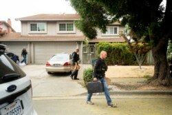 Police officers carry evidence bags from the family home of Gilroy Garlic Festival gunman Santino William Legan, July, 29, 2019, in Gilroy, Calif.