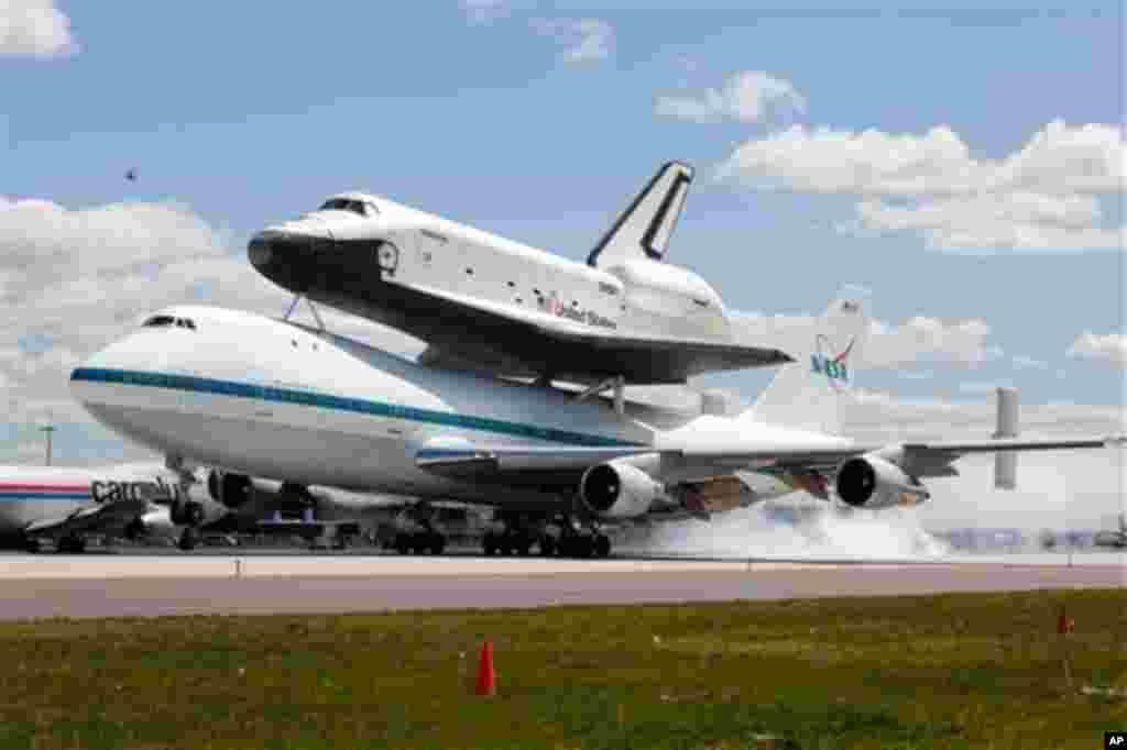 Space shuttle Enterprise, riding on the back of the NASA 747 Shuttle Carrier Aircraft, lands at JFK International Airport, Friday, April 27, 2012, in New York. Enterprise is eventually going to make its new home in New York City at the Intrepid Sea, Air 