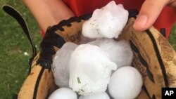 This photo provided by Stacey Valdez shows hail Valdez took in Sayre, Okla., May 16, 2017. The U.S. Midwest was hit by a large storm system again on Wednesday. 