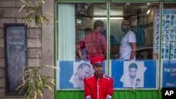  FILE - A security guard sits near a gate in Addis Ababa, Ethiopia, on October 10, 2016. A state of emergency in effect in Ethiopia since October 8 is being used broadly to silence critical media voices and lock up suspected dissidents, according to a range of reports coming in from the country.