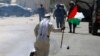 A Palestinian demonstrator runs past a tear gas canister launched by Israeli forces during a protest in solidarity with Palestinian prisoners held in Israeli jails near Israel&#39;s Ofer Prison in the occupied West Bank.