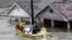 FILE - St. Bernard Parish Deputy Sheriff Jerry Reyes uses his boat to rescue residents after Hurricane Katrina hit the area causing flooding in their New Orleans neighborhood, Aug. 29, 2005.