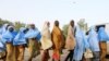 Girls who were kidnapped from a boarding school in the northwest Nigerian state of Zamfara walk in line after their release, in Zamfara, Nigeria, March 2, 2021.