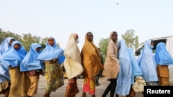 Girls who were kidnapped from a boarding school in the northwest Nigerian state of Zamfara walk in line after their release, in Zamfara, Nigeria, March 2, 2021.