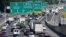 FILE - Traffic travels on Interstate 75, in Forrest Park, south of Atlanta, Sept. 8, 2017. The U.S. Department of Justice sued EZ Lynk on March 8, 2021, for selling devices that allow drivers to disable their vehicles' computerized emission controls.