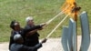 AU Commission Chairperson Moussa Faki Mahamat, Rwandan President Kagame, Jeannette Kagame and EU Commission President Juncker, light the Flame of Hope at the Genocide Memorial in Gisozi in Kigali, Apr. 7, 2019.