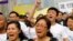 Family members of passengers on board Malaysia Airlines MH370 shout slogans during a protest in front of the Malaysian embassy in Beijing, March 25, 2014.