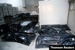 Bags with bodies of migrants who died after an air strike hit a detention center for mainly African migrants in Tajoura are seen in Tripoli Central Hospital, Libya, July 3, 2019.