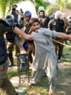 FILE - Police detain a supporter of Pakistan's former Prime Minister Imran Khan who with others was protesting against Khan's arrest, in Lahore, Pakistan, May 10, 2023.