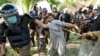 FILE - Police detain a supporter of Pakistan's former Prime Minister Imran Khan who with others was protesting against Khan's arrest, in Lahore, Pakistan, May 10, 2023.