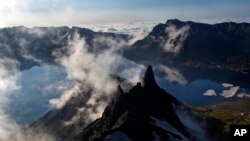  In this Wednesday, June 18, 2014 photo, clouds float over the peak of Mt. Paektu in North Korea's Ryanggang province. More than a thousand years ago, a huge volcano straddling the border between North Korea and China was the site of one of the biggest eruptions in history.