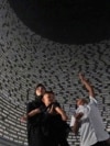 Visitors look at a wall displaying the names of the victims of 2004 Indian Ocean tsunami, at the Tsunami Museum in Banda Aceh, Aceh province, Indonesia, Dec 14, 2024. 