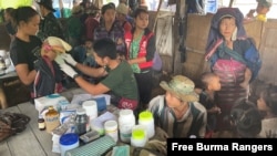 A Free Burma Rangers volunteer examines a baby in Yeh Mu Plaw village, Karen state, Burma. (File)