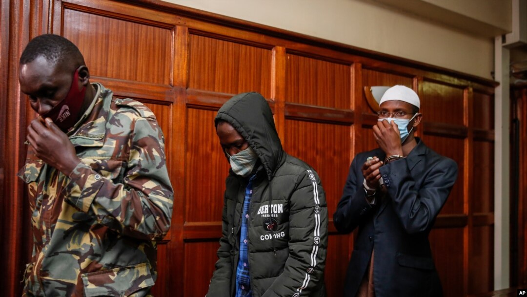 Hussein Hassan Mustafah, center, and Mohamed Ahmed Abdi, right, who were both found guilty of supporting the gunmen involved in the Westgate Mall attack in Sept. 2013, leave after the verdict is delivered at Milimani court in Nairobi, Kenya, Oct. 7, 2020.