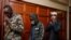 Hussein Hassan Mustafah, center, and Mohamed Ahmed Abdi, right, who were both found guilty of supporting the gunmen involved in the Westgate Mall attack in Sept. 2013, leave after the verdict is delivered at Milimani court in Nairobi, Kenya, Oct. 7, 2020.