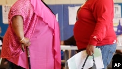 FILE - Two women converse in New York, June 26, 2012. The nation's obesity epidemic continues to grow, led by an alarming increase among women. Obesity is one of the risk factors of heart failure.