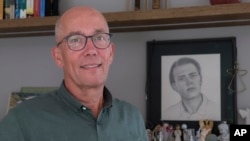 Thomas Schansman poses in front of a drawing of his son, Quinn, at his home in the central Dutch city of Hilversum, Netherlands, July 11, 2024.