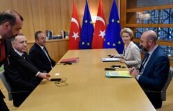 Turkish President Recep Tayyip Erdogan, 2nd left, meets with European Council President Charles Michel, right, and European Commission President Ursula von der Leyen, 2nd right, at the European Council building in Brussels, Belgium, March 9, 2020.