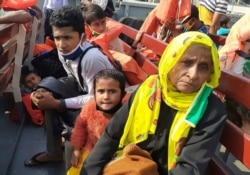 Rohingya refugees board a ship as they are ferried to Bhashan Char, or floating island, in the Bay of Bengal, from Chittagong, Bangladesh, Dec. 4, 2020.