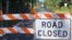 A sign stands near the Carter's Crossroads community in Georgetown County, a road adjacent to Boser Swamp is flooded over, Wednesday, Sept. 26, 2018, in Georgetown County, S.C. This is one of many lowlying areas in this and other nearby farming communities where roads are blocked off days after the rains of Florence have stopped. 