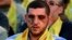 A Hezbollah fighter who was wounded in Qusair, Syria, listens to a speech by Hezbollah leader Sheik Hassan Nasrallah, not shown, during a rally in the southern suburb of Beirut, Lebanon, Friday, June 14, 2013.