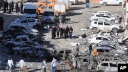 People inspect the damage from an overnight bomb attack in Viransehir, Turkey, Feb. 18, 2017. The bomb exploded near the homes of judges and prosecutors in the mainly-Kurdish town in Sanliurfa province, which borders Syria.