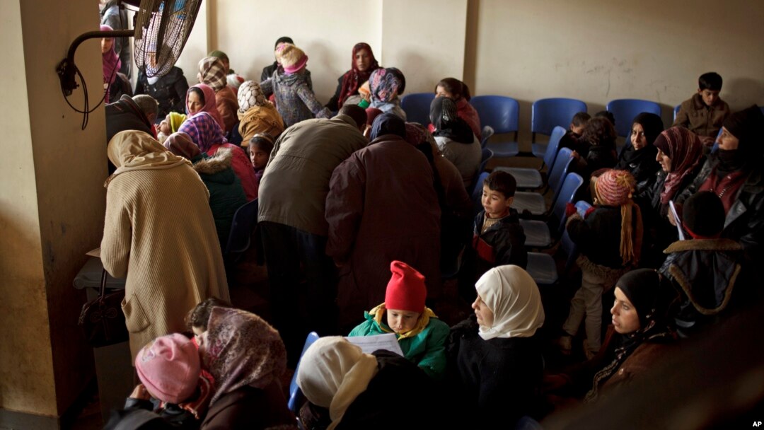 FILE - Syrians waiting for their appointments at the U.N. refugee agency's registration center in Zahleh, in Lebanon's Bekaa Valley.