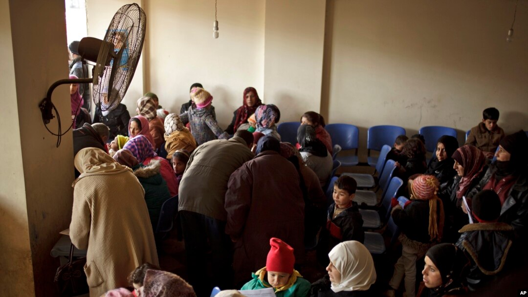 FILE - Syrians waiting for their appointments at the U.N. refugee agency's registration center in Zahleh, in Lebanon's Bekaa Valley. In Lebanon, Dec. 18, 2013