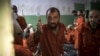 FILE - Men suspected of being affiliated with the Islamic State group gather in a prison cell in the northeastern Syrian city of Hasakah, Oct. 26, 2019.