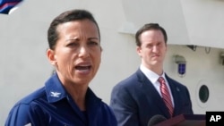 U.S. Coast Guard Capt. Jo-Ann Burdian, foreground, with Homeland Security Investigations Special Agent in Charge in Miami Anthony Salisbury, speaks during a news conference, Jan. 27, 2022, at Coast Guard Sector Miami in Miami Beach, Fla.