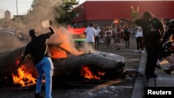 George Floyd protesters set Minneapolis police station afire