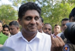 Presidential candidate of Sri Lanka's governing party Sajith Premadasa displays the indelible ink on his finger after casting his vote in Weerawila, Sri Lanka, Nov. 16 , 2019.
