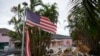 FILE - A tattered American flag flaps outside a home damaged by Hurricane Helene, ahead of the arrival of Hurricane Milton in Holmes Beach on Anna Maria Island, Florida, Oct. 8, 2024.