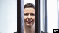 FILE - In this photo taken on Aug. 04, 2021, Maria Kolesnikova smiles inside the defendants' cage at the opening of her trial in Minsk.