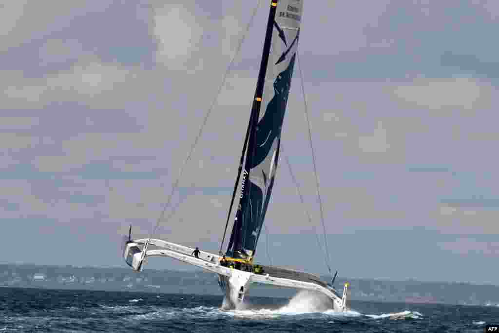 French skippers Charles Caudrelier and Franck Cammas sail on their multihull "Maxi Edmond de Rothschild" off the coast of Lorient, western France, during a training session ahead of the Rolex Fastnet yacht race.