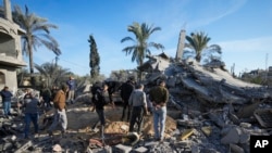 Palestinians look at home destroyed by an Israeli strike late Saturday in Deir al-Balah, Dec. 22, 2024. At least eight people were killed according to the hospital which received the bodies.